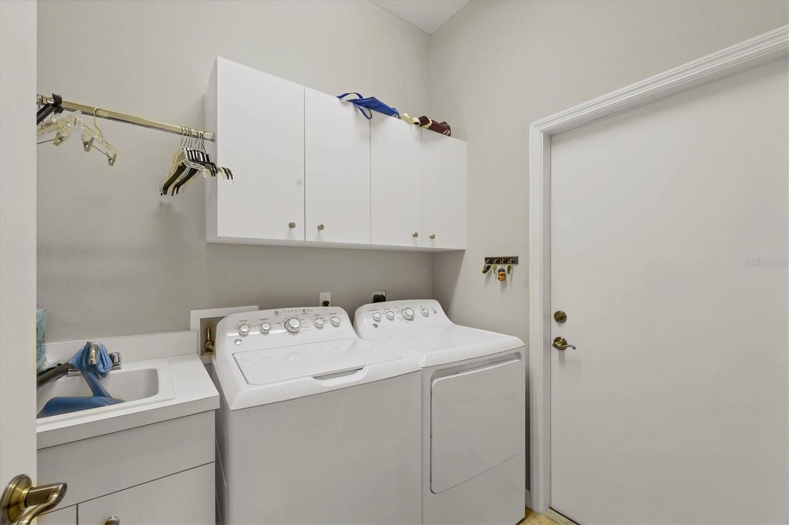 Laundry room includes a utility sink.  It's located between the kitchen & the garage