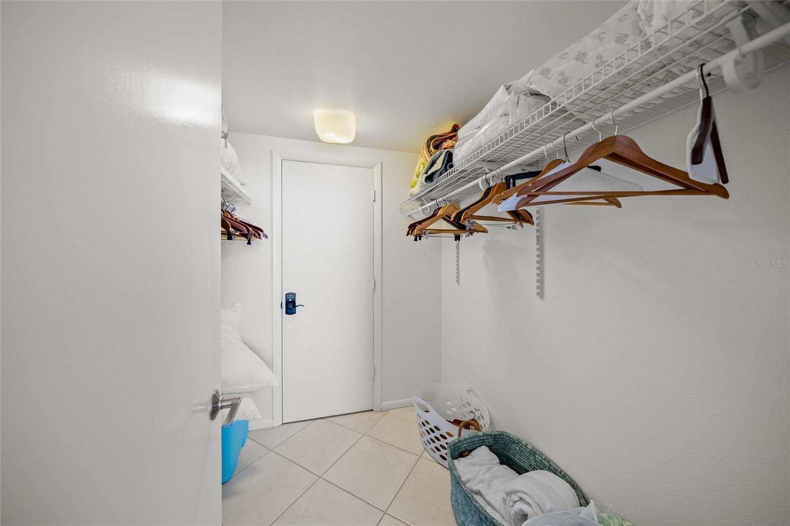 Master bedroom walk-in closet with separate owners closet