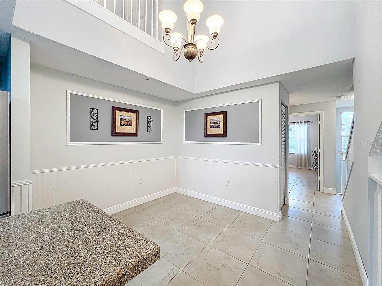 Centered on the 2nd floor is the dining room with soaring 2 story ceilings and windows bringing in lots of natural light.