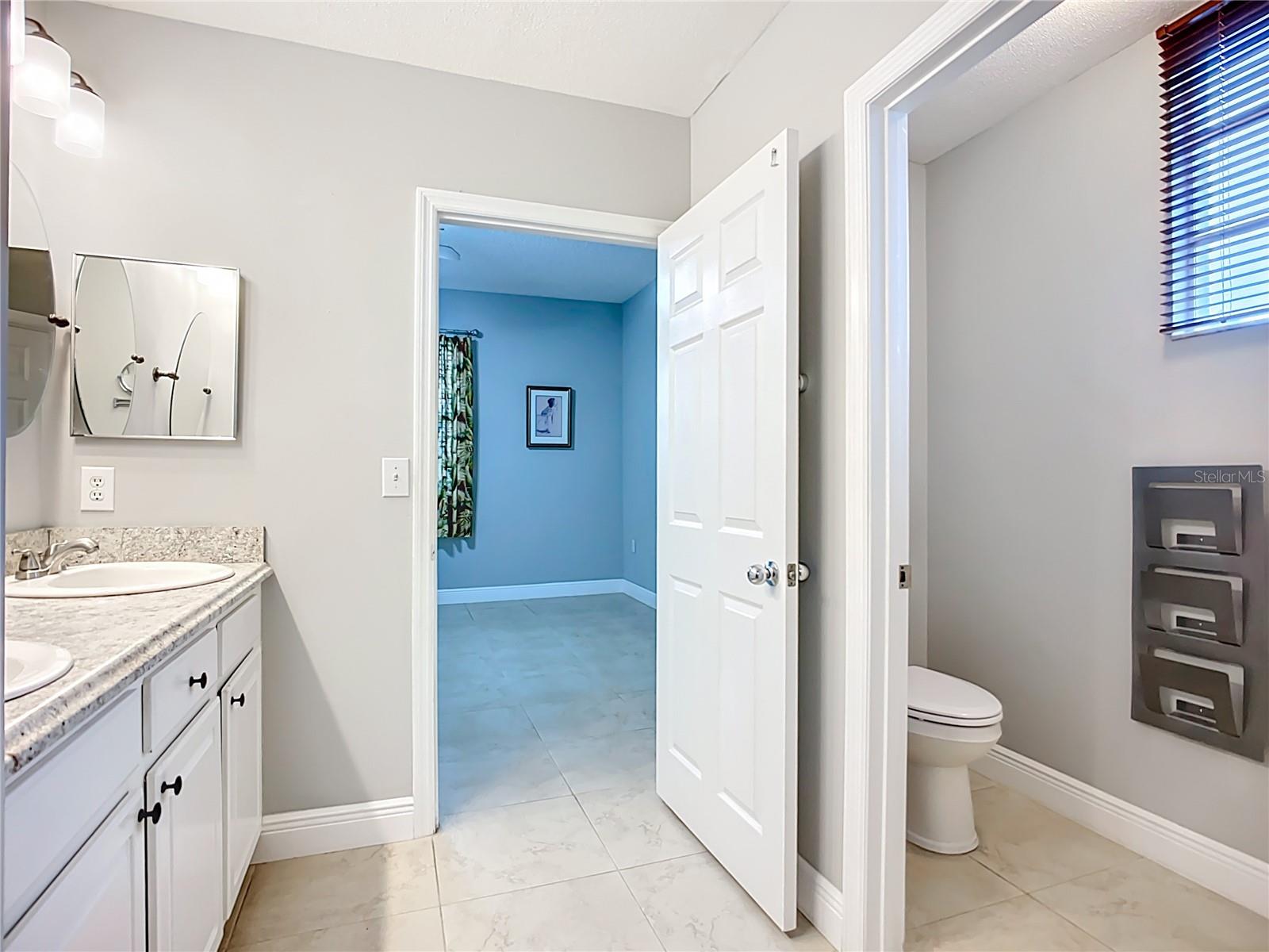 Private toilet room across from sinks