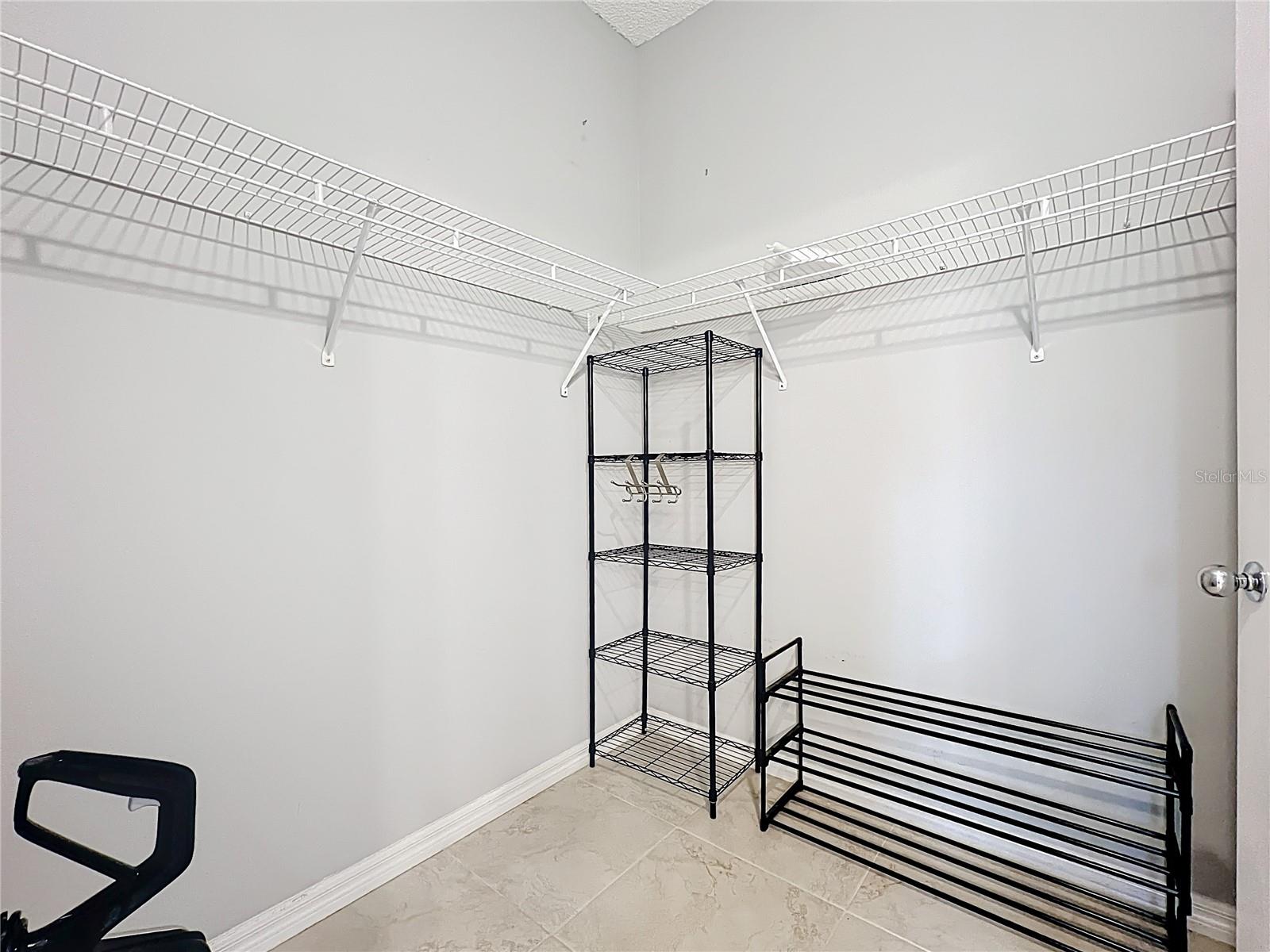 Large walk-in closet centered between sink/toilet side and tub shower
