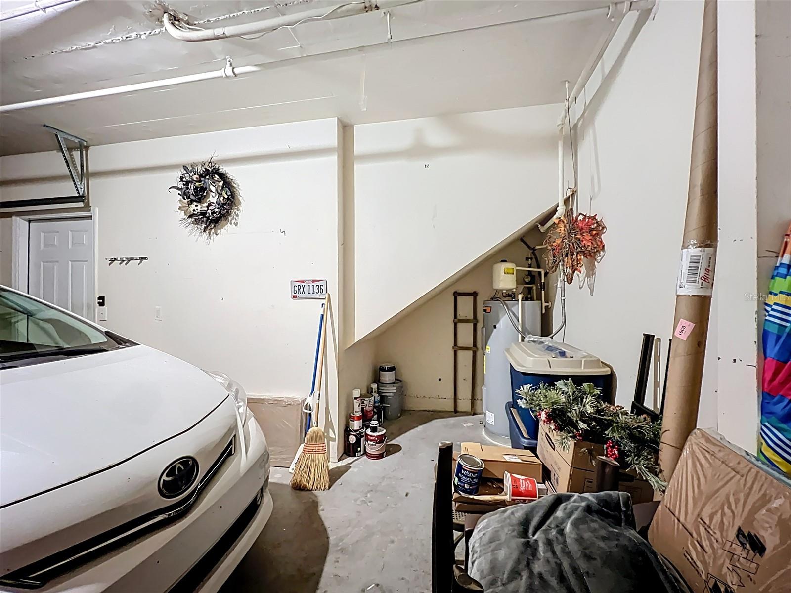Under stair storage and water heater located in garage