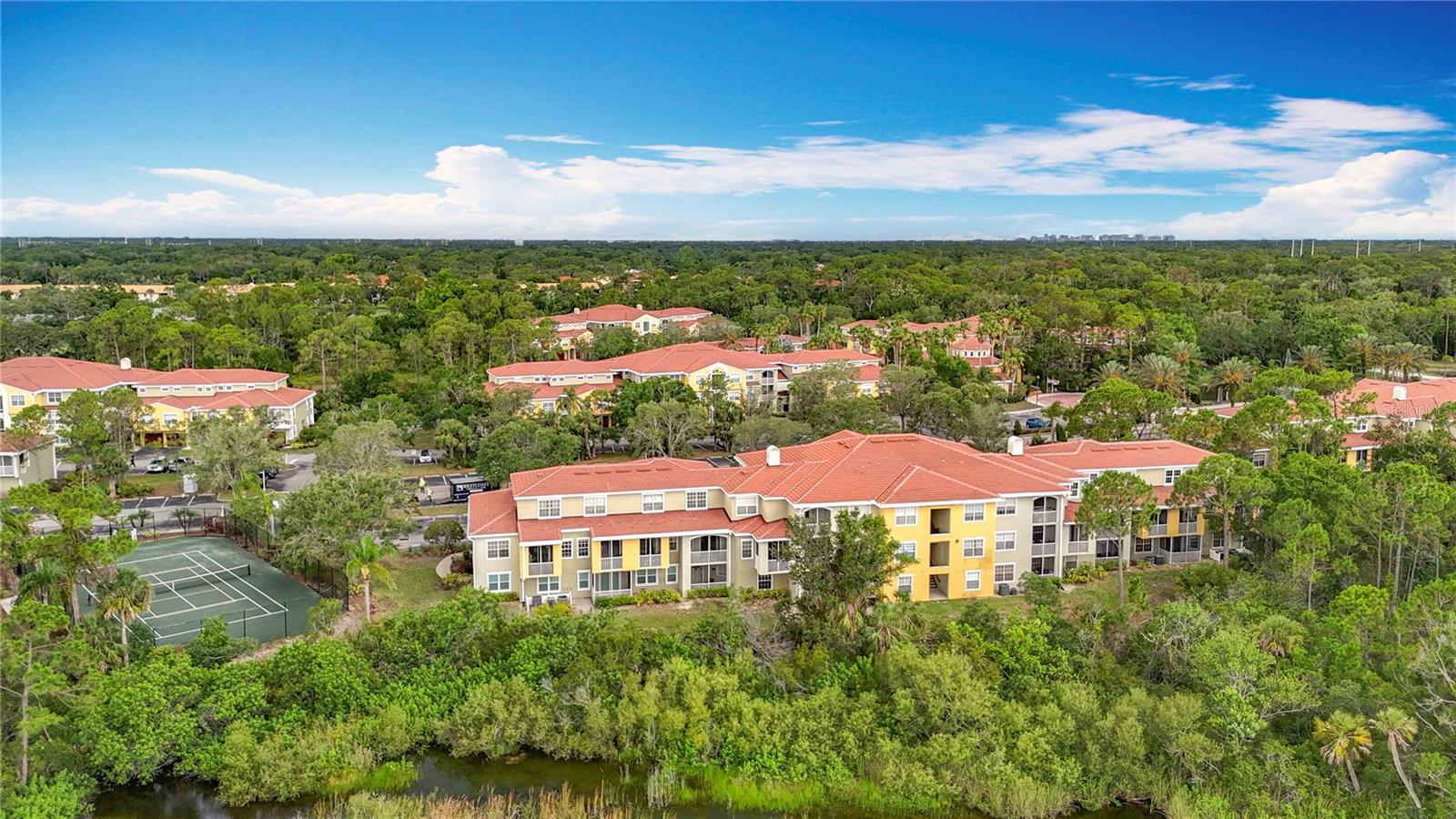 View from back of townhome with tennis court at left