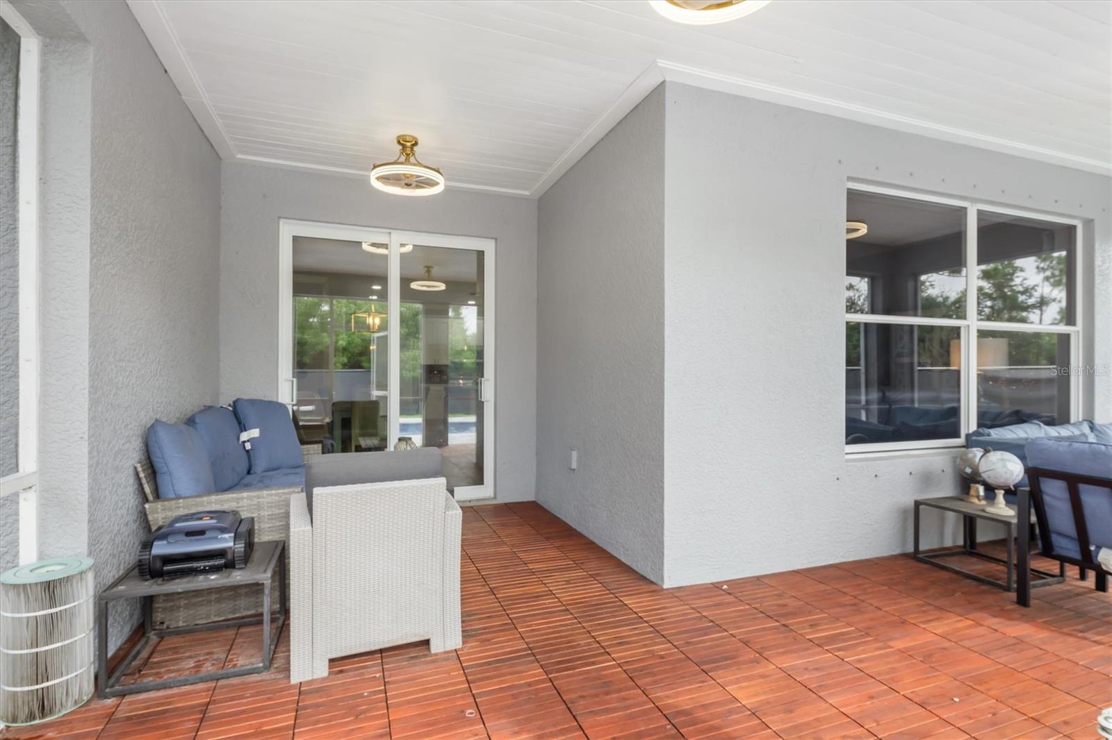 L-shaped space accommodates table, chairs and sofas.