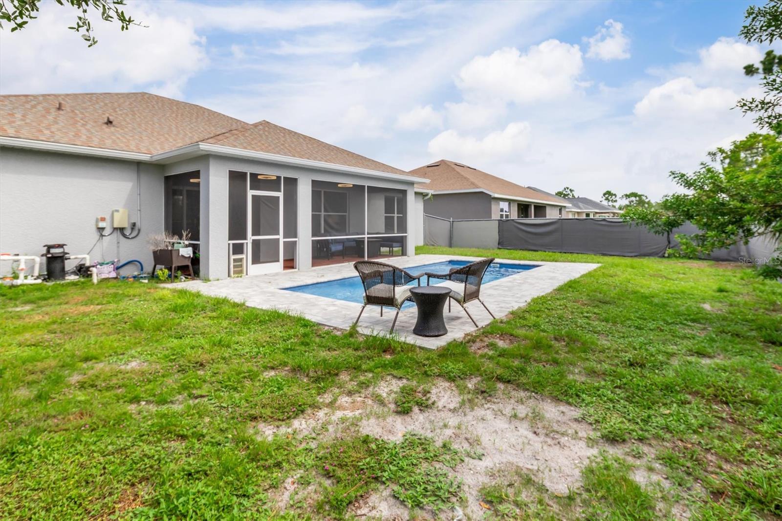Large fenced lot with space around pool.