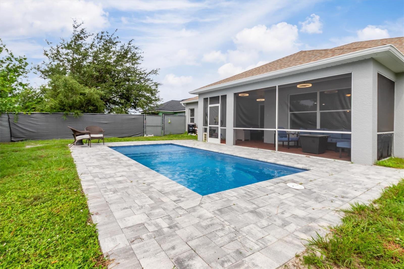 Pavers around pool allow for sunbathing.