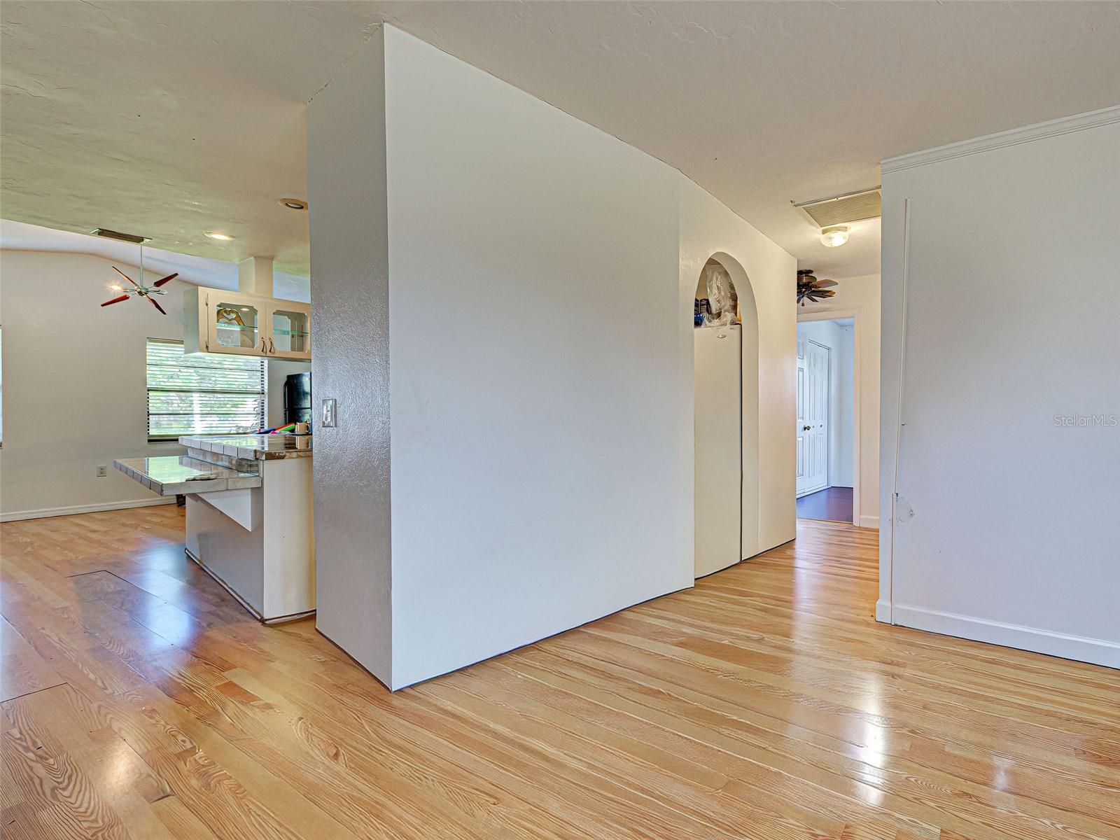 Hallway to the right with  2 bedrooms and a bath