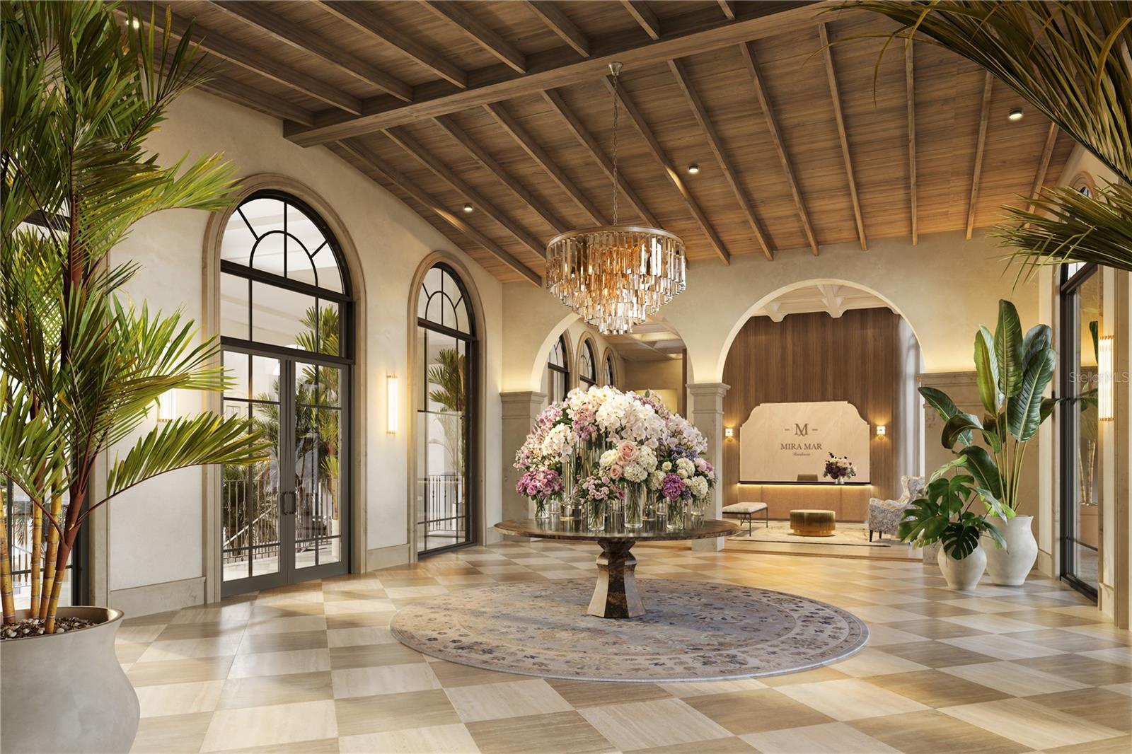 The Grand Lobby at Mira Mar offers a refined arrival experience, overlooking a beautifully landscaped courtyard and showcasing timeless architecture, natural light, and sophisticated finishes.