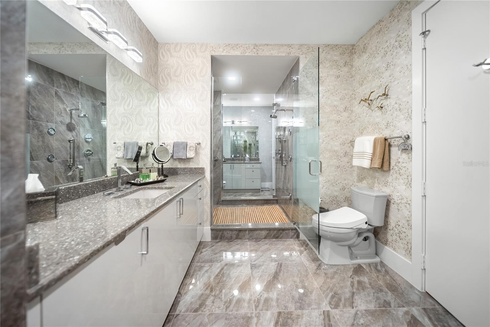 Primary bathroom - his and her side connected by spa-like shower