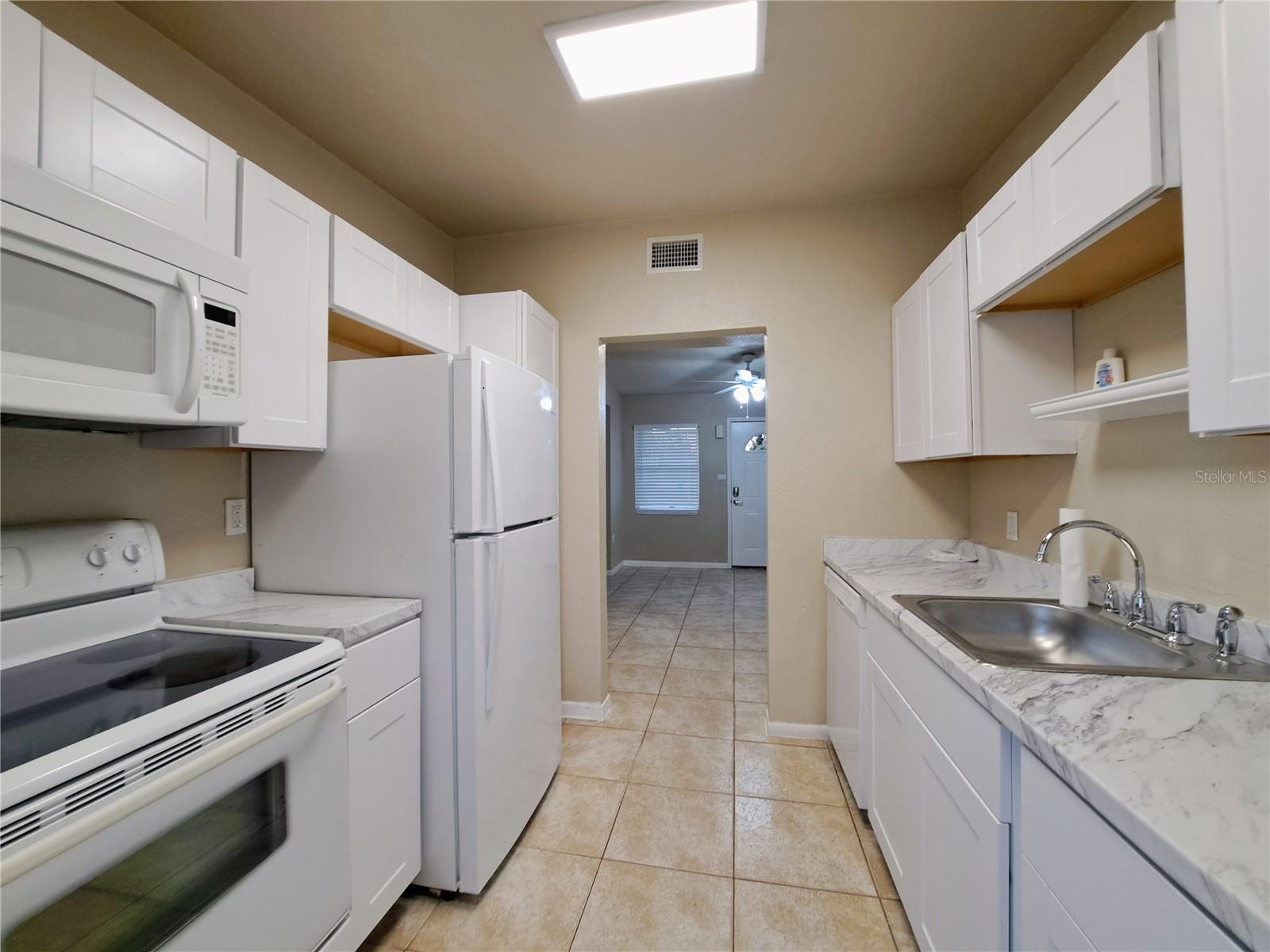 Galley style Kitchen off main Living space with exterior access.