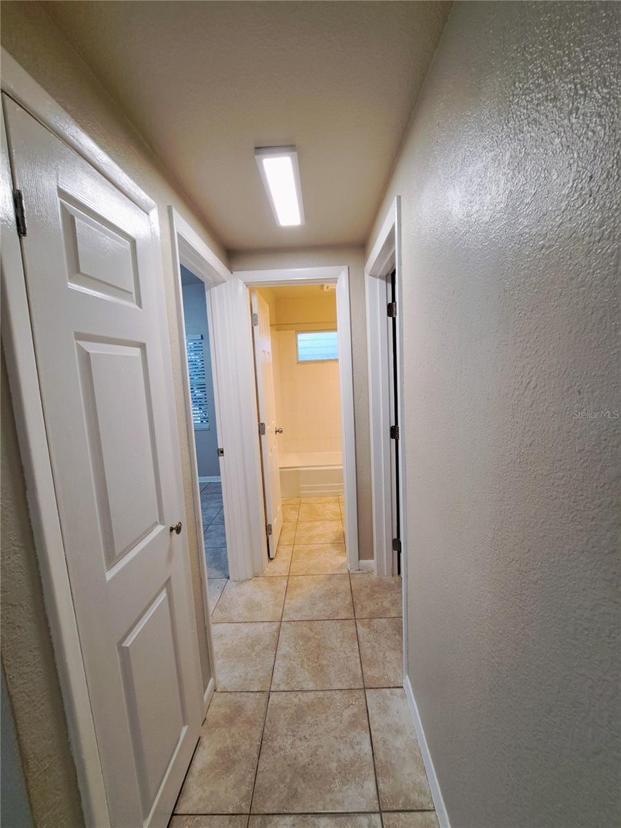 Hallway leading to Bed #2, Guest Bath and Primary Bedroom.