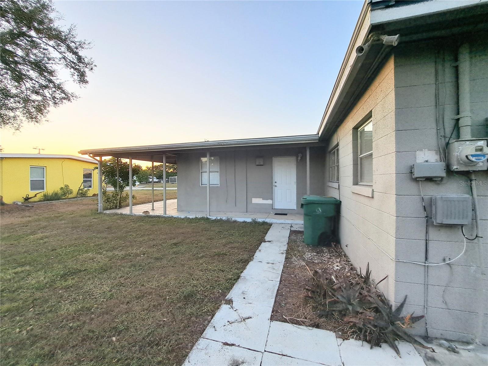 Two exterior access doors to the rear of home. Wrap around walkway from both access points to Carport would allow for private entry and exit.