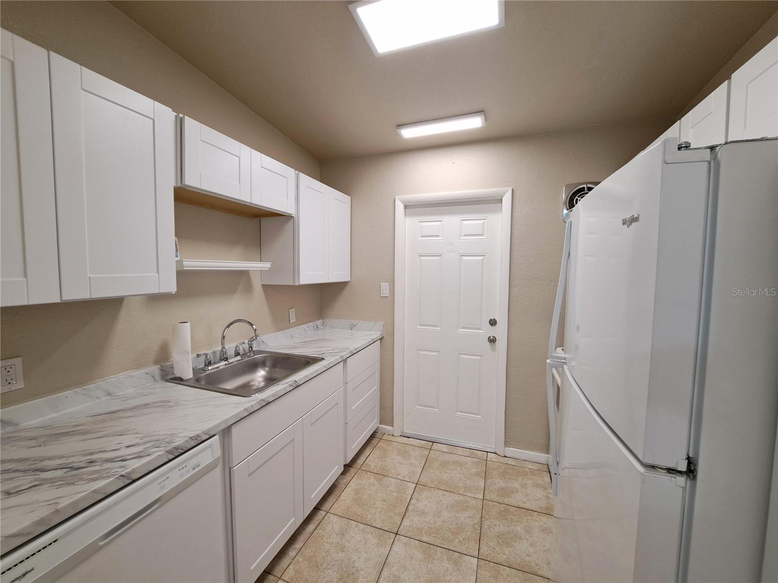 Galley style Kitchen off main Living space with exterior access.