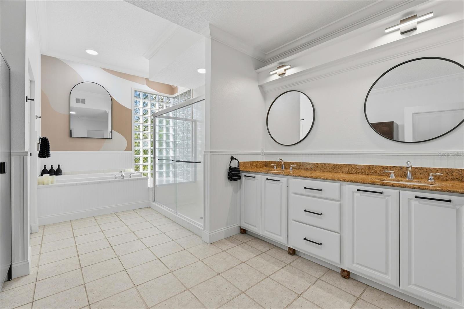 main bath has natural light from window and glass blocks