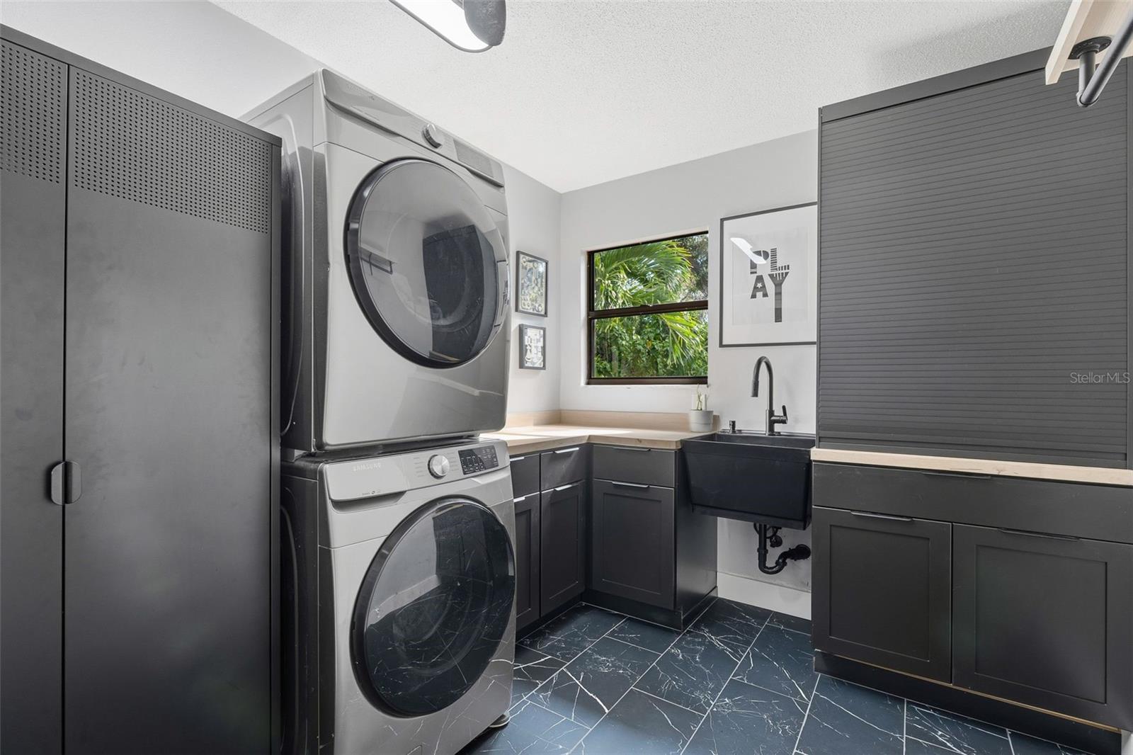 quaint laundry room has natural light and a peaceful view