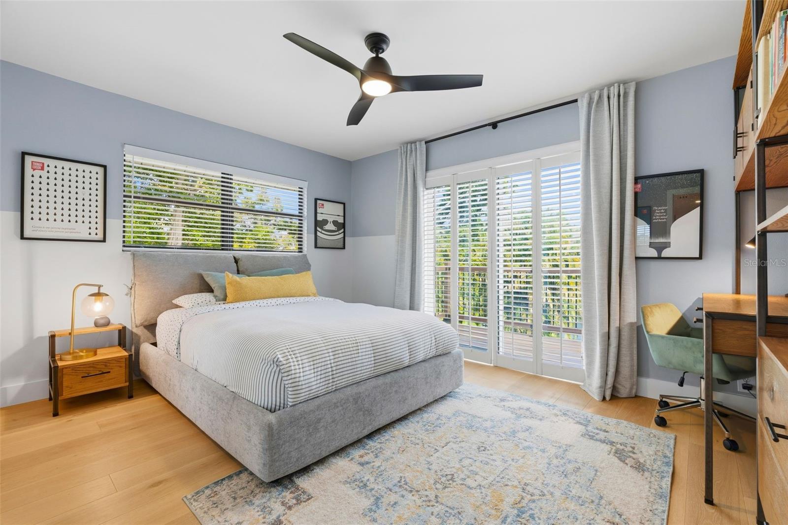 upstairs bedroom with doors leading to balcony