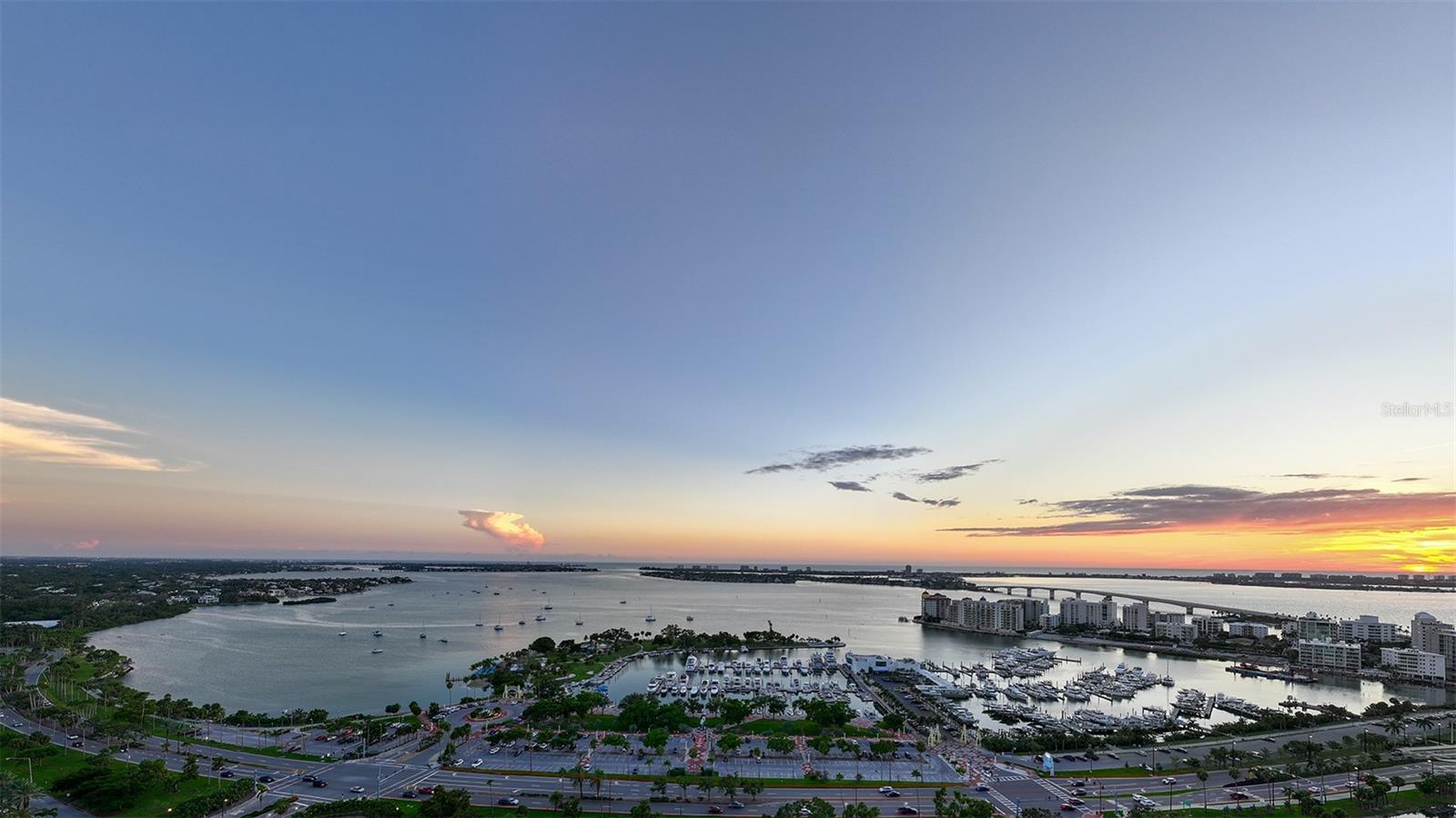 Sweeping panoramic views from the Sky Speakeasy showcase Sarasota Bay, The Gulf of Mexico, and the iconic Ringling Bridge, creating a breathtaking backdrop for unforgettable sunset moments high above the city.