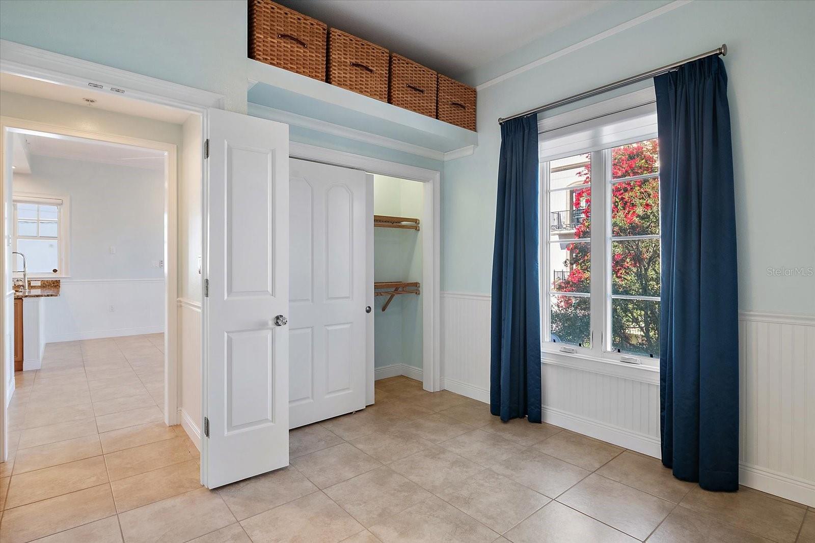 Primary bedroom entrance and closet and courtyard facing window