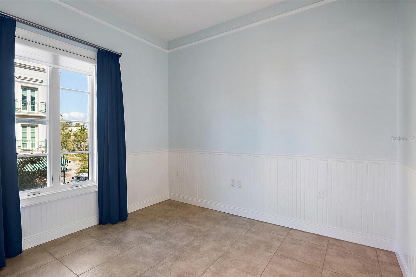 Primary bedroom window facing courtyard with natural light