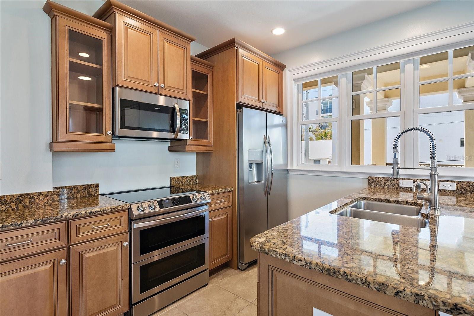 Kitchen with granite countertops and wood cabinetry