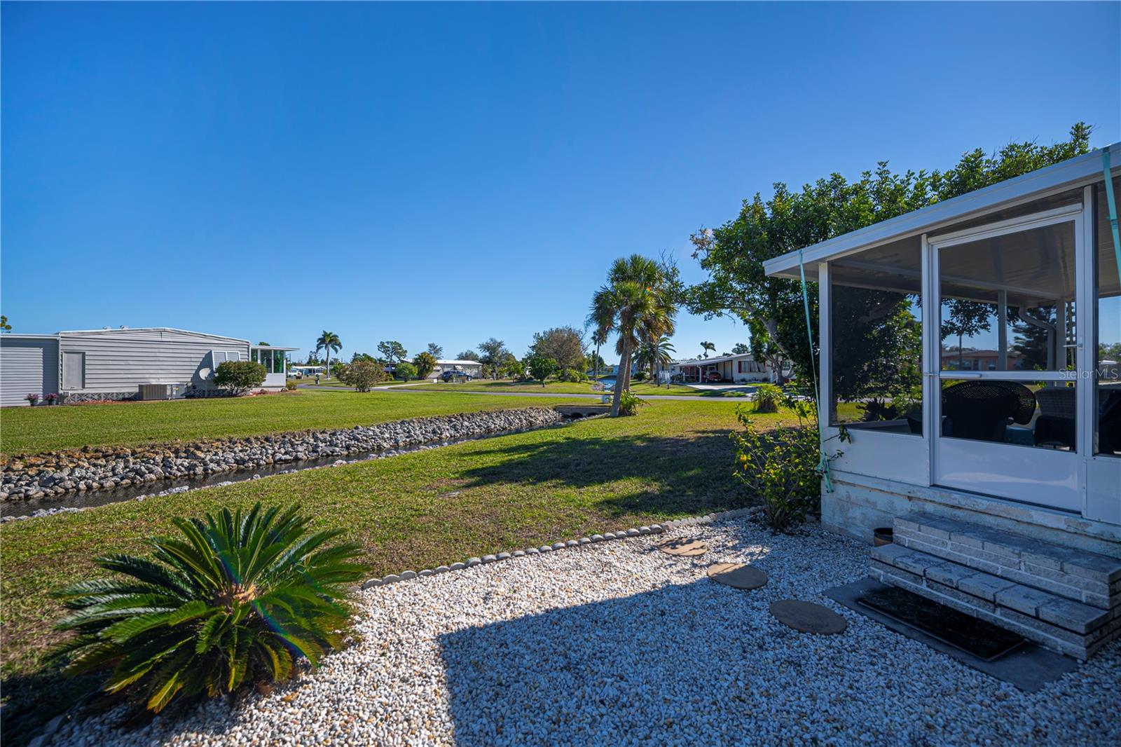 beautiful rear yard with the canal and patio area.