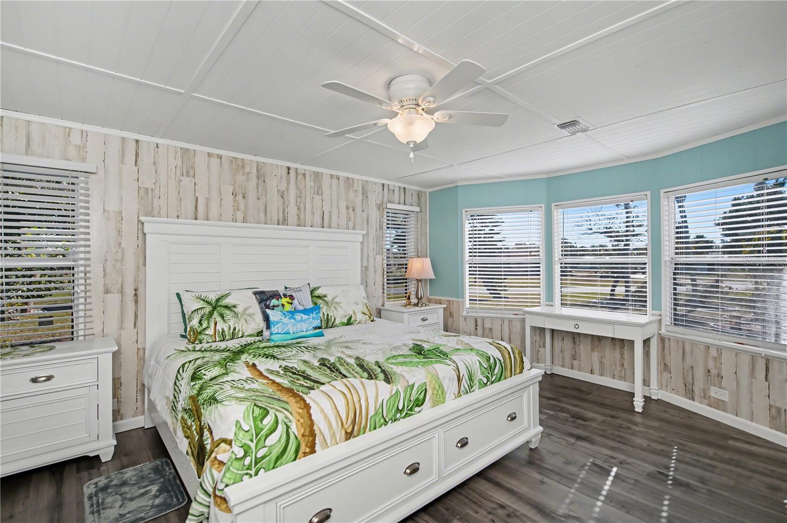 The grand primary bedroom has plenty of room for a King sized bed along with additional furnishings.  The wall of windows makes it light and airy.