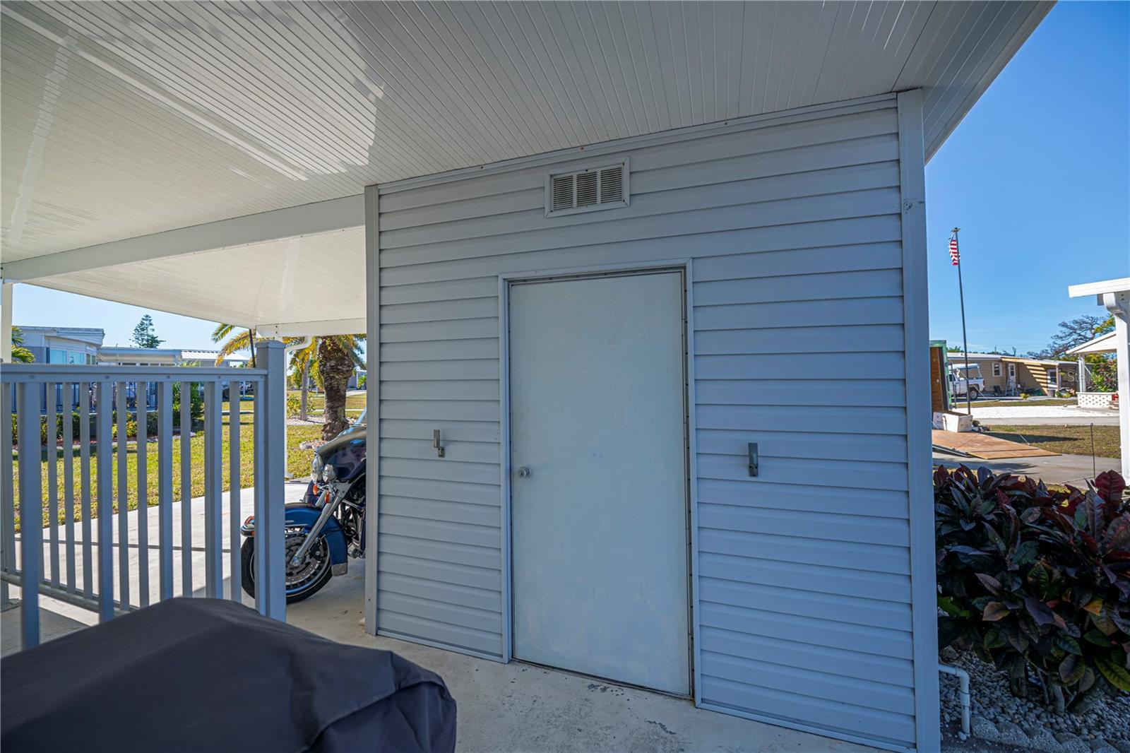 Right outside on the front porch is the utility building with washer and dryer hookups plus plenty of space for storage.