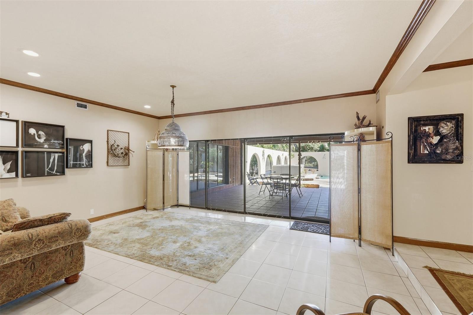 Spacious Living Room with Sliders to Covered Lanai/Pool Area