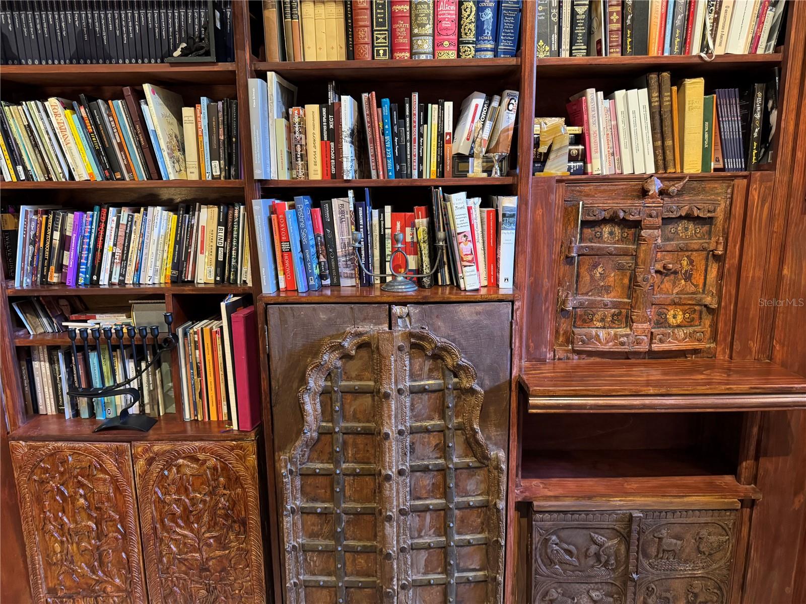 Old World Wood Carvings in Bookcase of Family Room