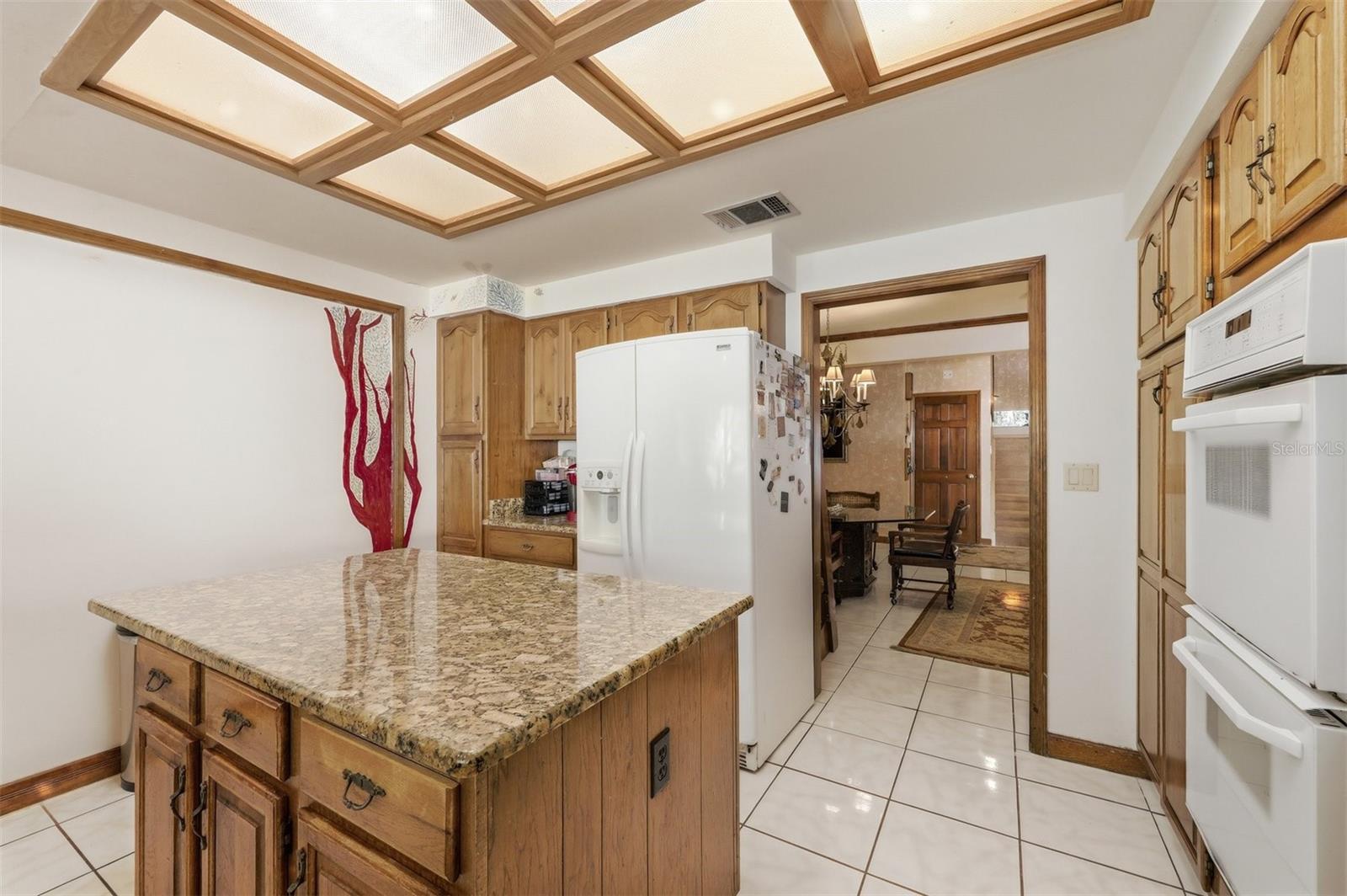 Kitchen with Double Ovens, Granite Counters and Center Island.
