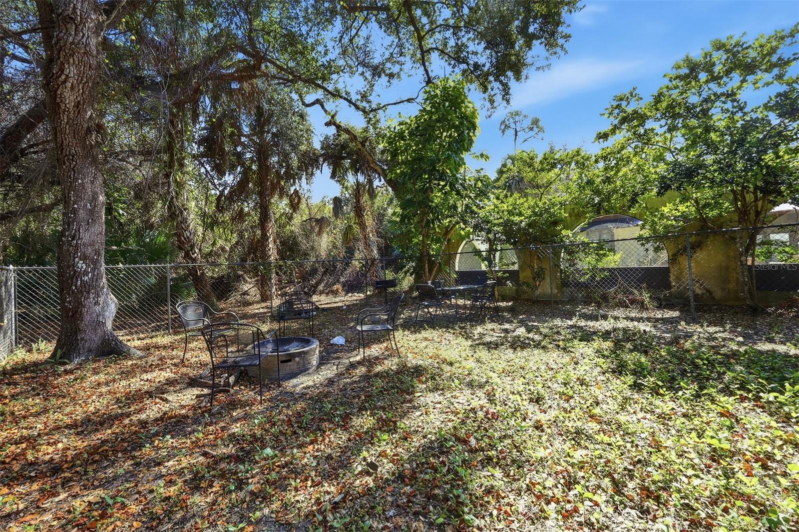 Fenced-In Firepit Area in Real of Property
