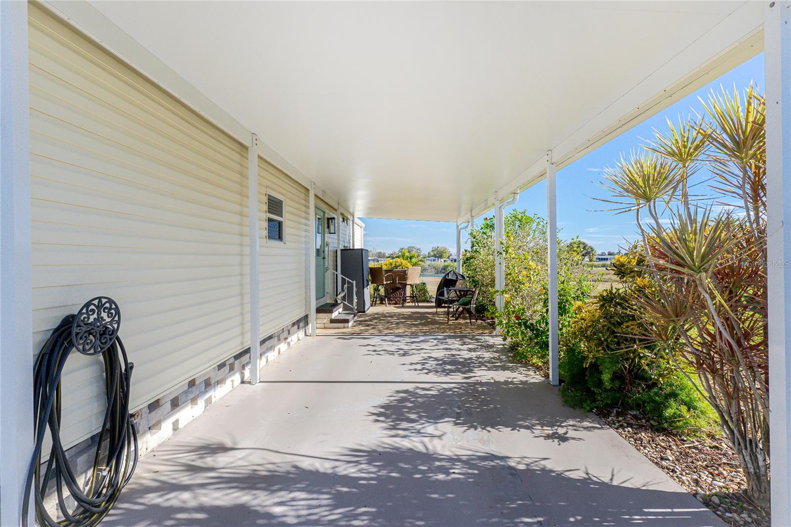 Carport built to current Codes in 2024.  Looks like 2 vehicles can park here, plus there is a generous driveway.Hmm what about storing your boat under here?