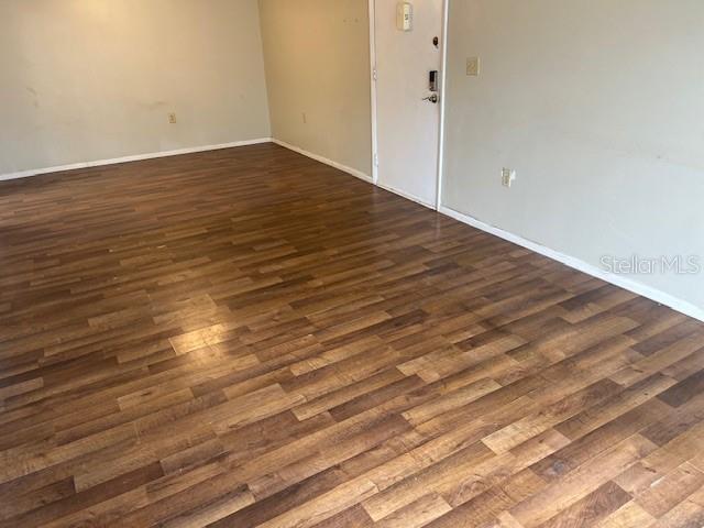 Living rm looking into dining area, unit door on right.
