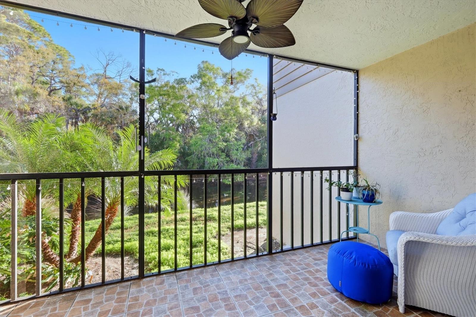 Large screened in back lanai overlooking the footbridge and creek