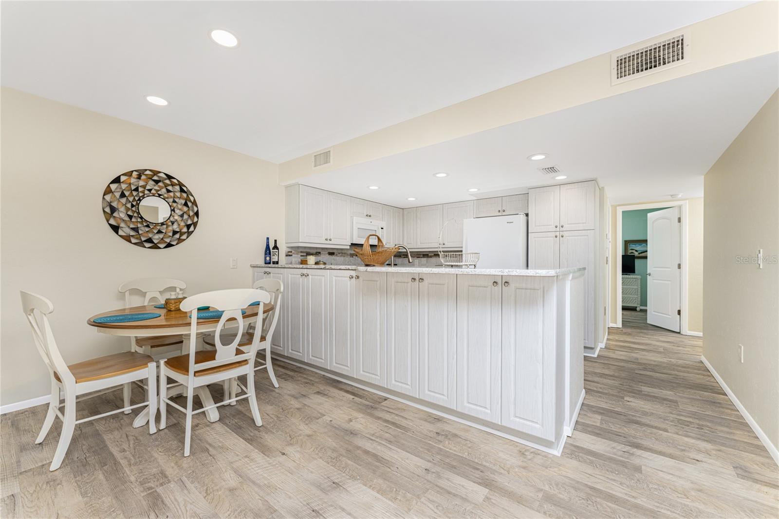 Cabinetry under the breakfast bar provides additional storage