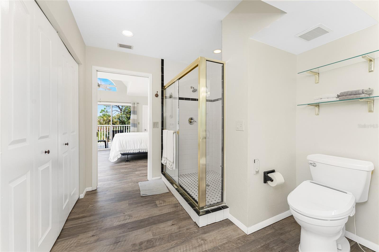 Luxurious primary bath features step in shower with doors....