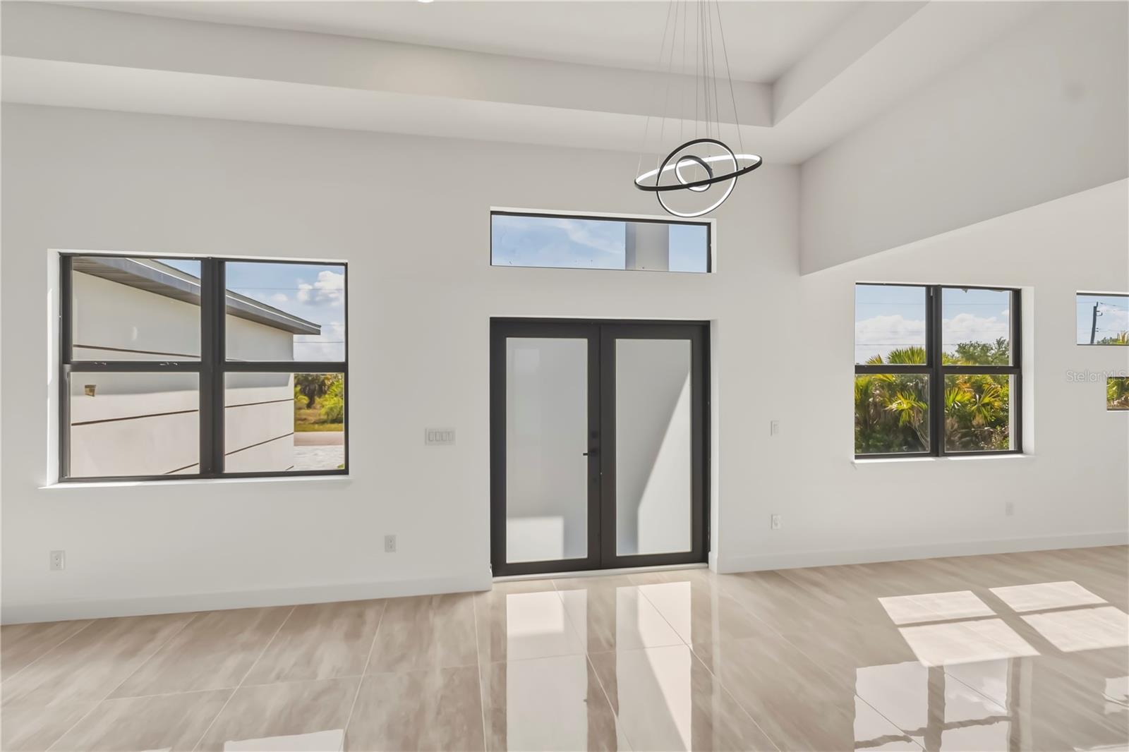 Grand Living Area with Soaring Tray Ceilings and Natural Lights.