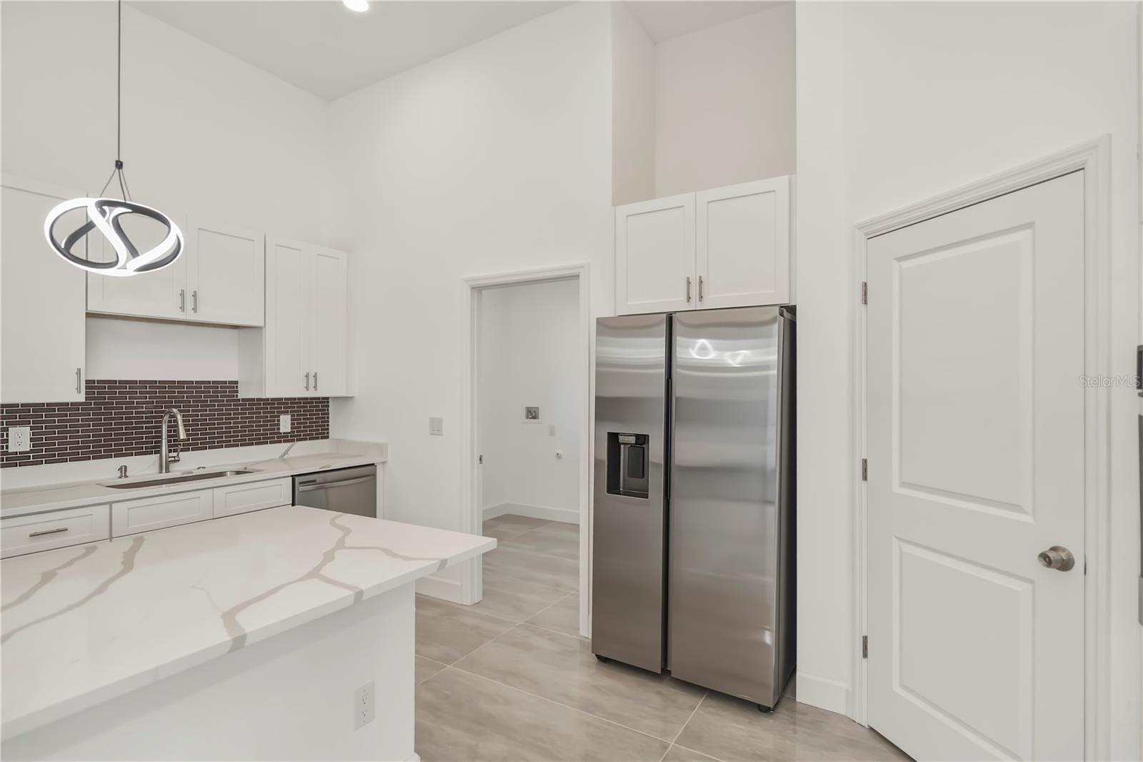 Chefs Kitchen with Walk-In Pantry and Quartz Island.
