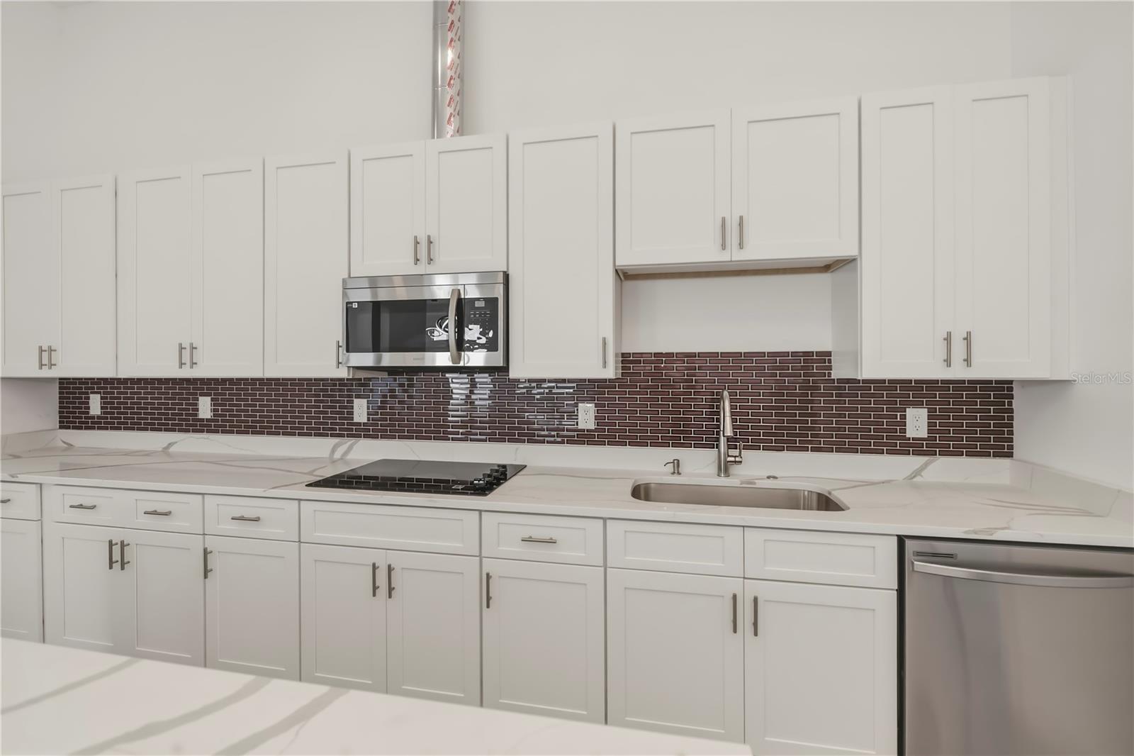 Chef's Kitchen with Oversized Quartz Waterfall Island.