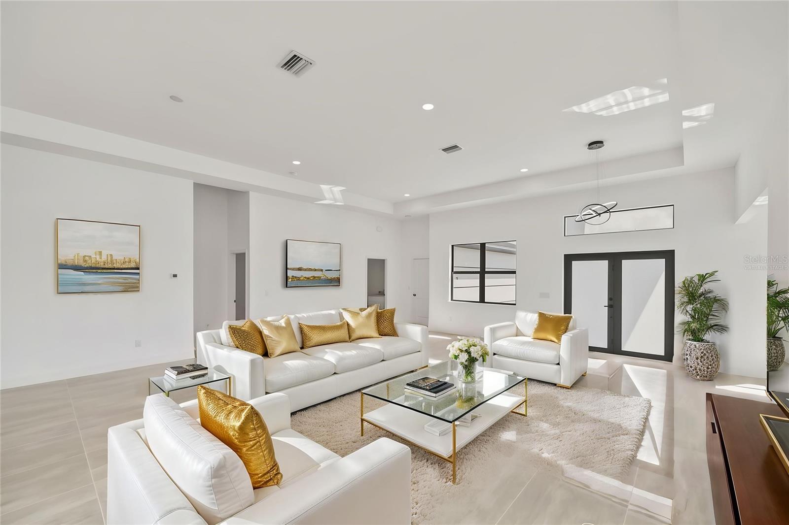 Virtually Staged Open Living Room with Tray Ceiling.
