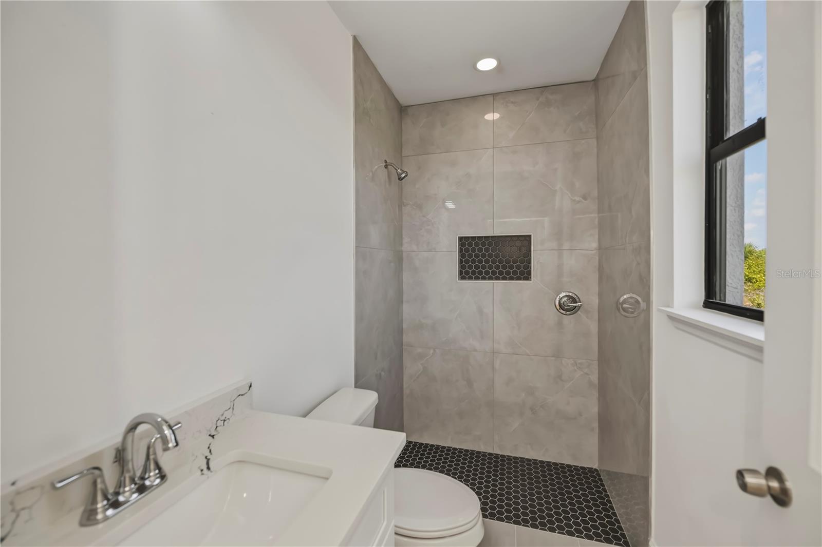 Third Bathroom with Tiled Walk-In Shower.
