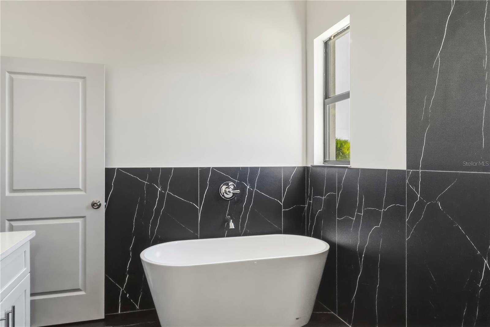 Spa-Inspired Primary Bath with Free Standing Soaking Tub.