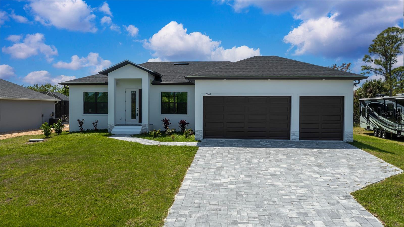 Modern 2025 Custom Home with Paver Driveway.