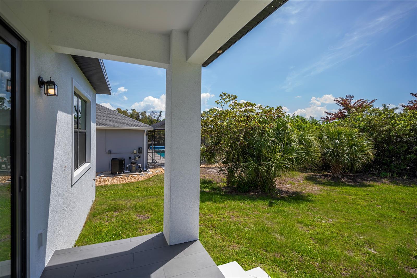 Covered Lanai Overlooking Private Backyard.
