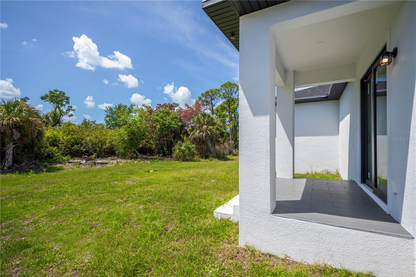 Covered Lanai Overlooking Private Backyard.