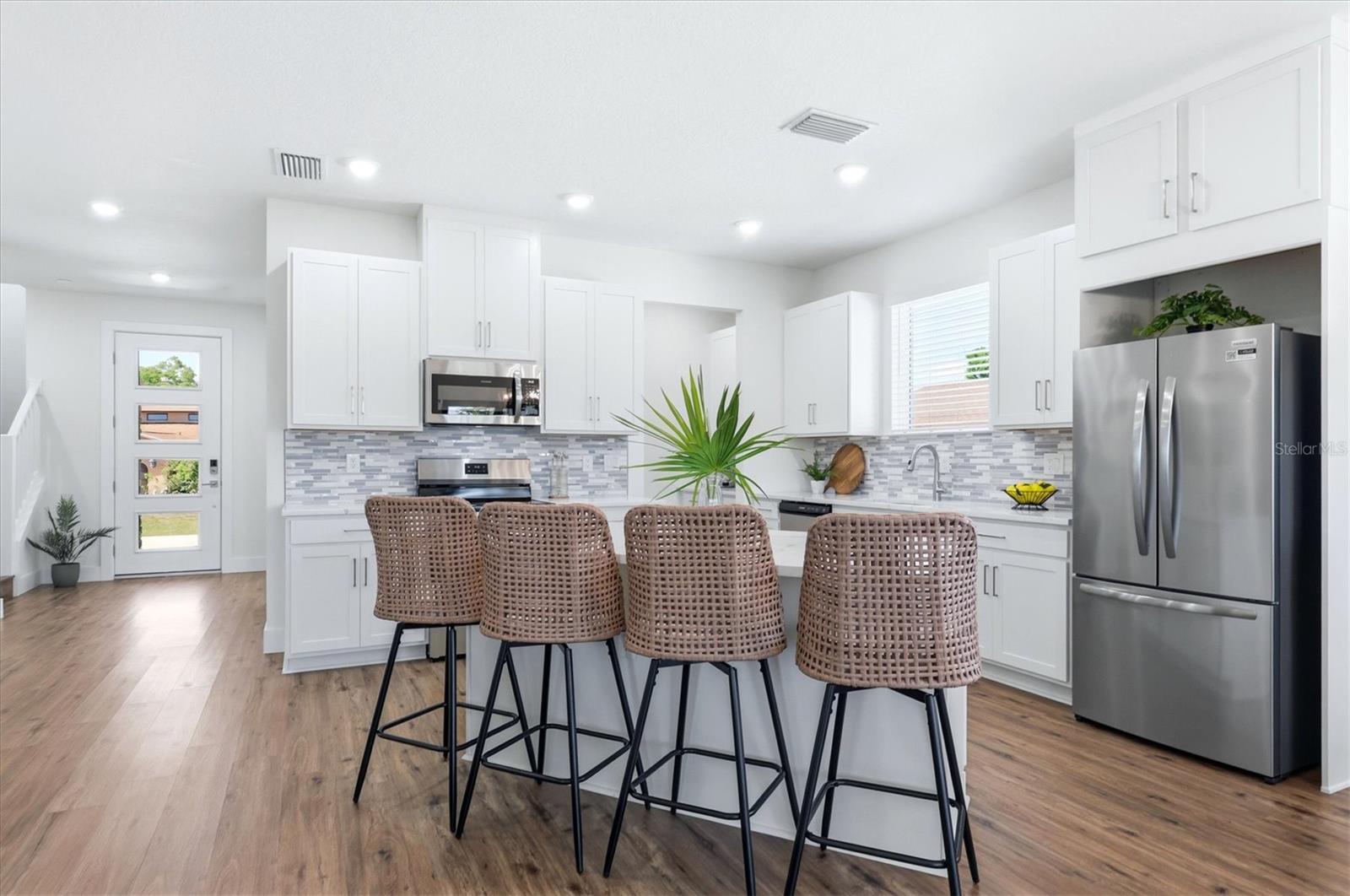 Light and bright kitchen with dining island, butler's pantry and walk-in pantry too