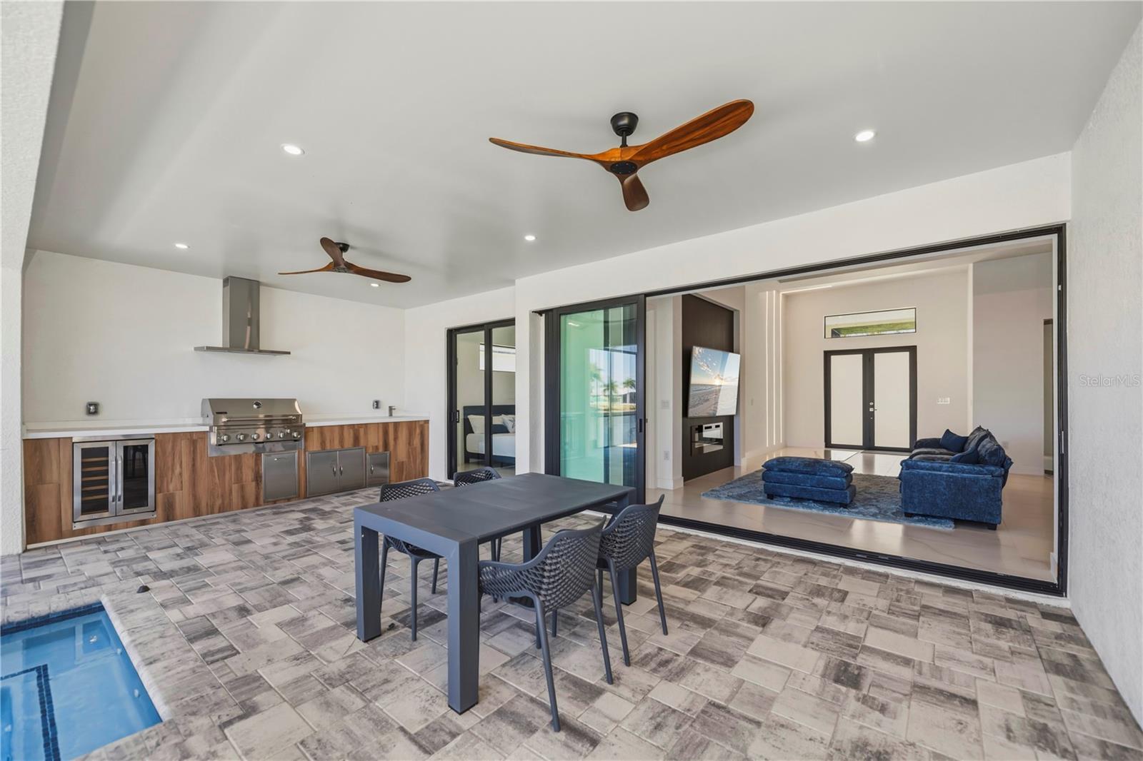 Covered Lanai with Outdoor Kitchen and Pool Access.