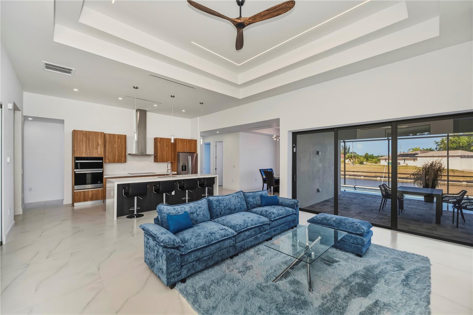 Living Room with Multi-Tier Tray Ceiling and Water Views.