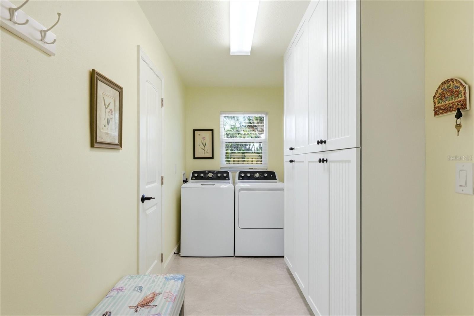 Downstairs Indoor Laundry Room with added cabinetry for storage