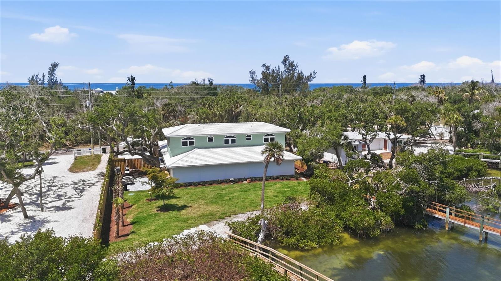 Aerial of Back of Home with Hurricane Shutters